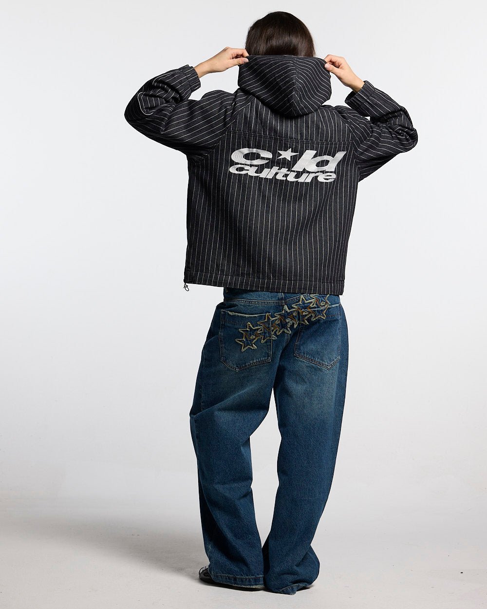 STRIPES CASINO JACKET NAVY - navy pinstripe hooded jacket, back view on female model - Cold Culture #woman