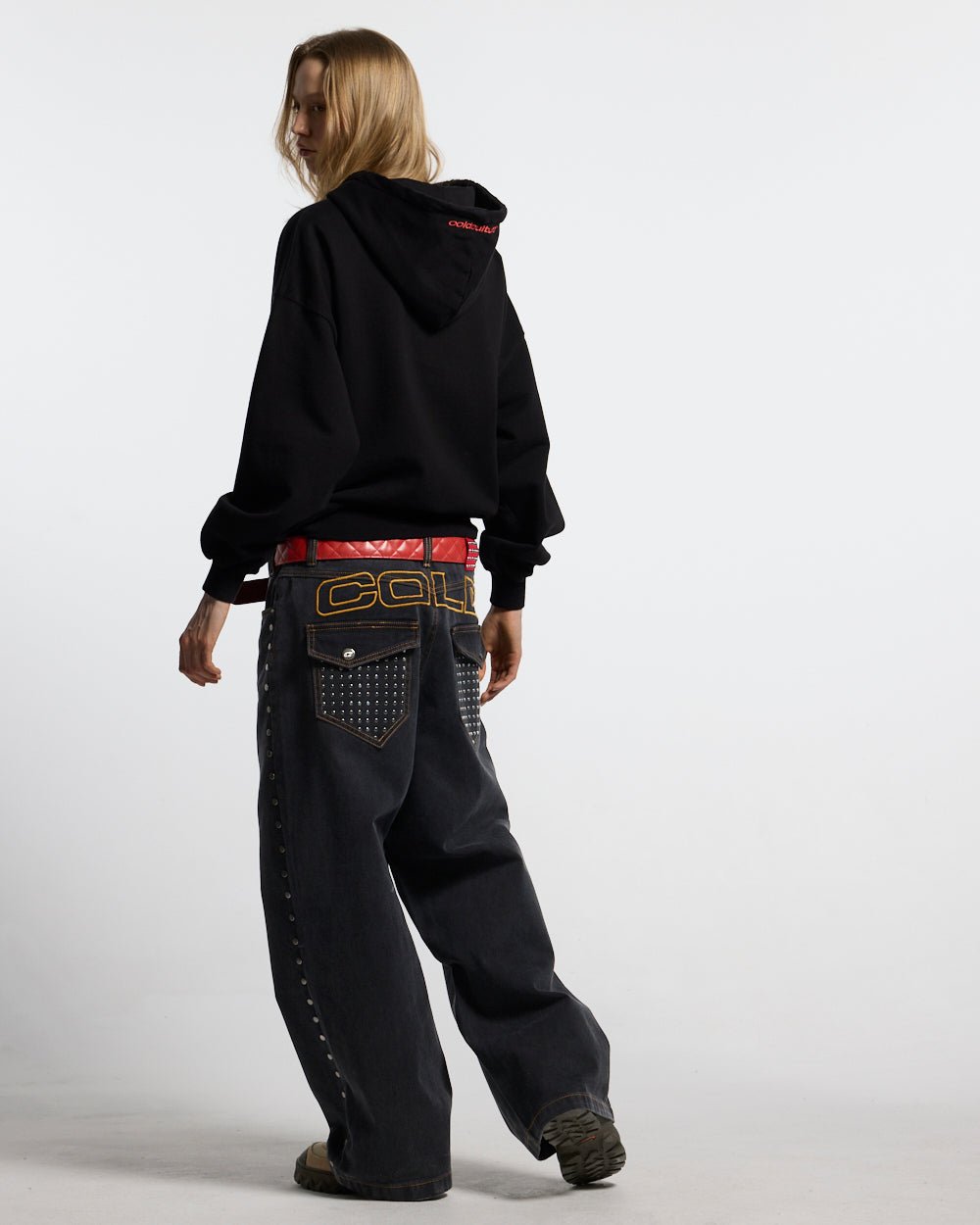 STUDS PANTS BLACK DENIM - black studded denim pants, back view on female model - Cold Culture #woman