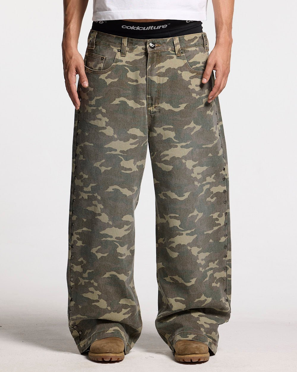 STUDS PANTS CAMO - camo studded pants, front view on male model - Cold Culture