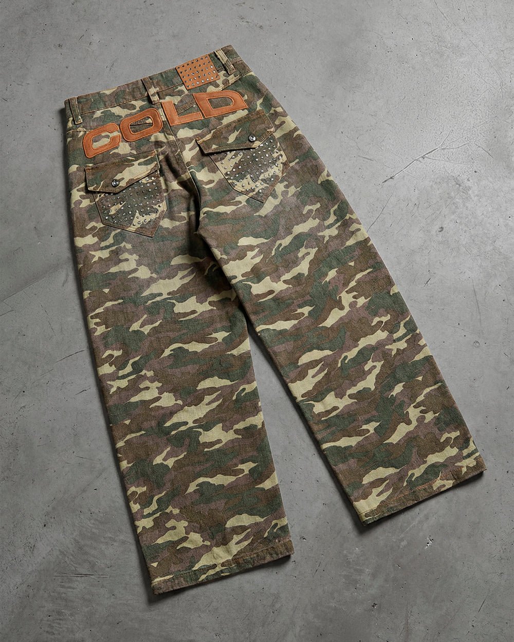STUDS PANTS CAMO - camo studded pants, flat lay - Cold Culture