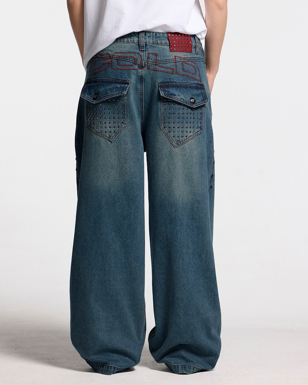 STUDS PANTS LIGHT BLUE DENIM - washed blue studded denim pants, back view on female model - Cold Culture #woman