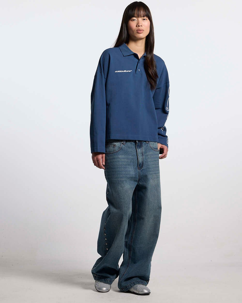 STUDS PANTS LIGHT BLUE DENIM - washed blue studded denim pants, front view on female model - Cold Culture #woman