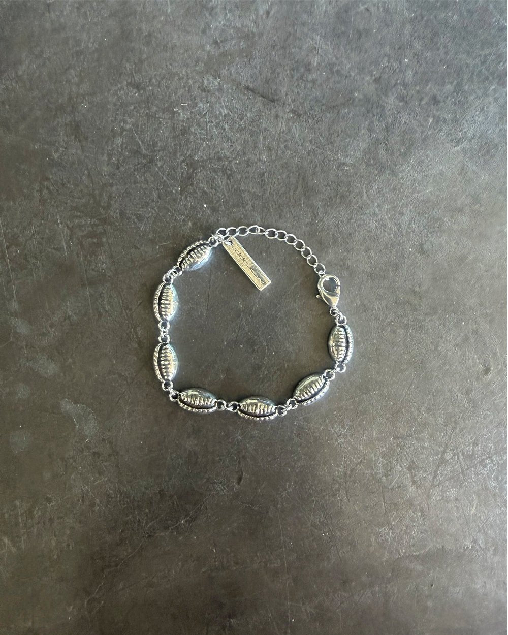 SUNSET BRACELET SILVER - silver shell link bracelet, flat lay - Cold Culture