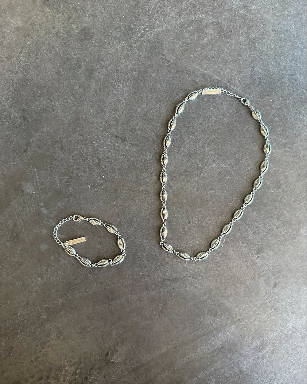 SUNSET BRACELET SILVER - silver shell link bracelet, flat lay with matching pieces - Cold Culture