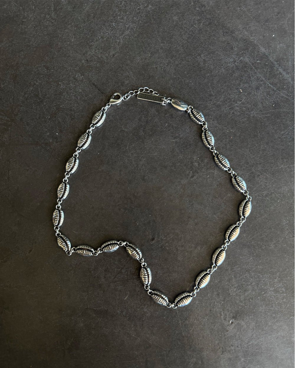 SUNSET NECKLACE SILVER - silver shell link necklace, flat lay - Cold Culture