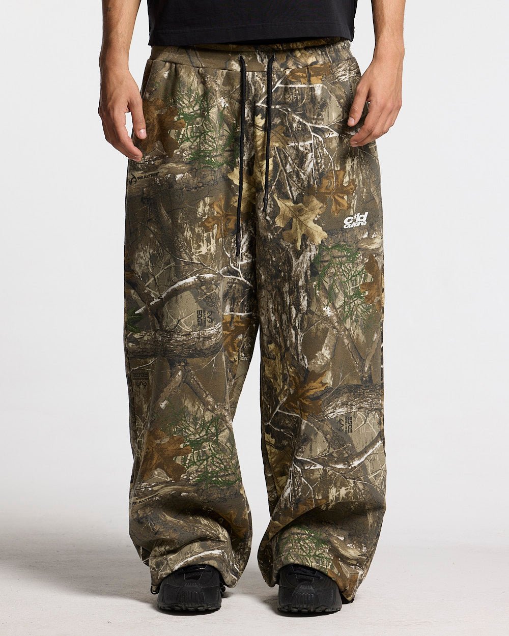 SWEATPANTS REALTREE EDGE - brown camo sweatpants, front view on male model - Cold Culture