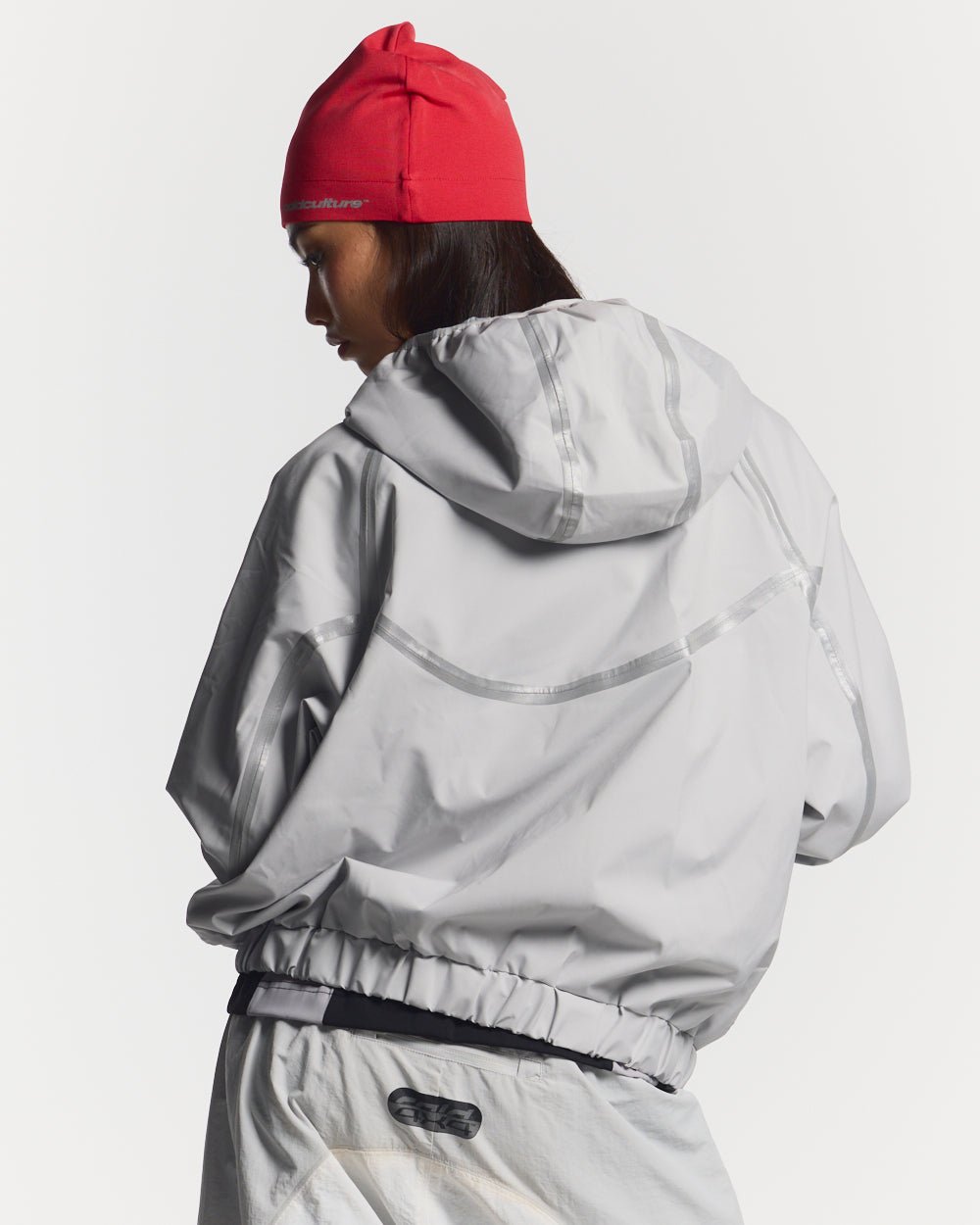 TAKE OFF LIGHTWEIGHT JACKET LIGHT GREY - light grey reflective trim jacket, back view on female model - Cold Culture #woman