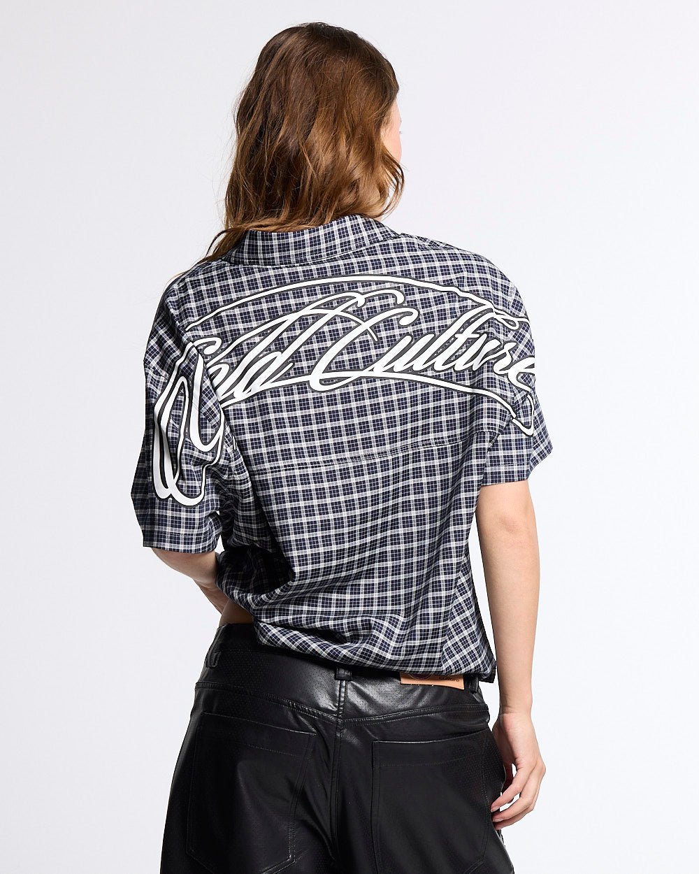 TARTAN SCRIPT SHIRT BLACK - black plaid short sleeve shirt, back view on female model - Cold Culture #woman