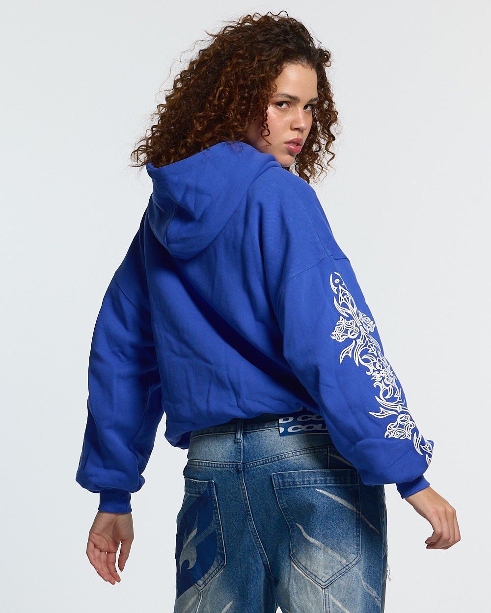 TRIBAL HOODIE BLUE - blue tribal print hoodie, back view on female model - Cold Culture #woman