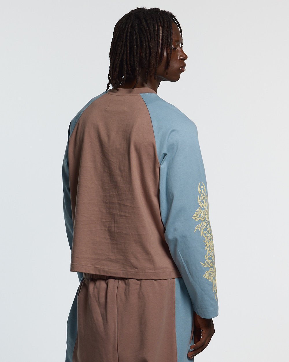 TRIBAL LONGSLEEVE BROWN & BLUE - brown and blue tribal longsleeve tee, back view on male model - Cold Culture #man