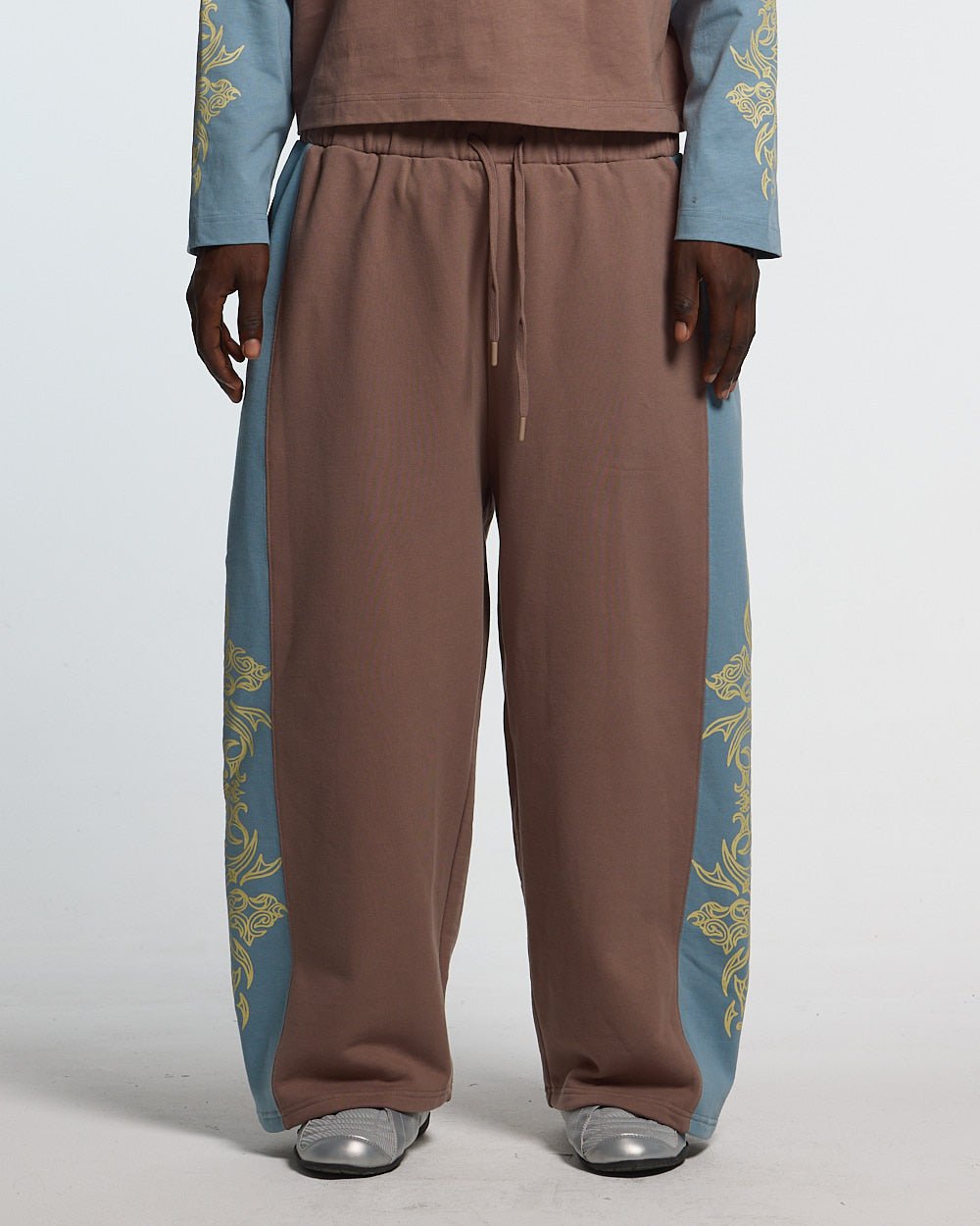 TRIBAL SWEATPANTS BROWN & BLUE - brown and blue tribal sweatpants, front view on male model - Cold Culture