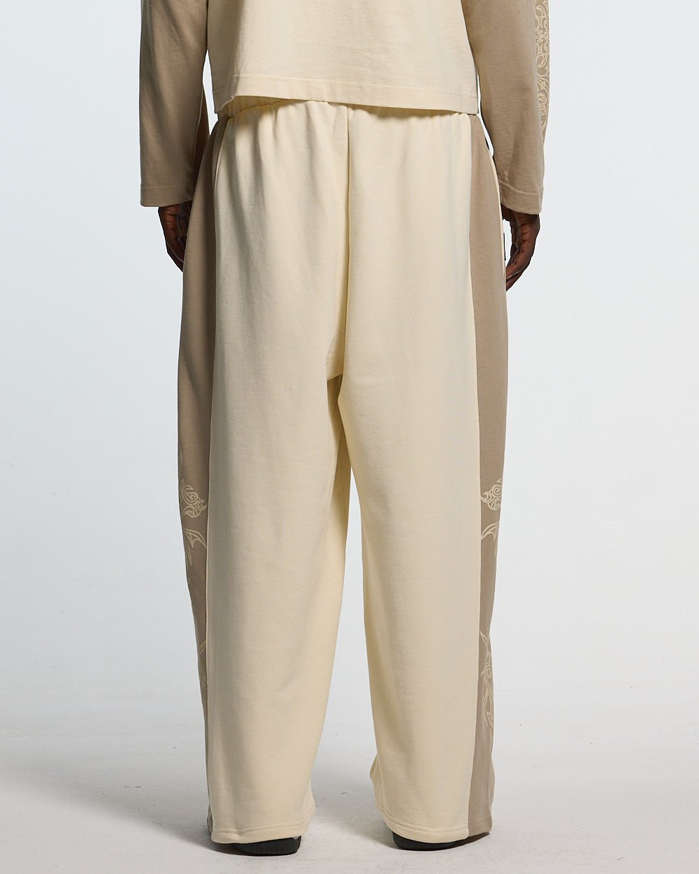 TRIBAL SWEATPANTS GREY & OFF WHITE - off white tribal sweatpants, back view on male model - Cold Culture