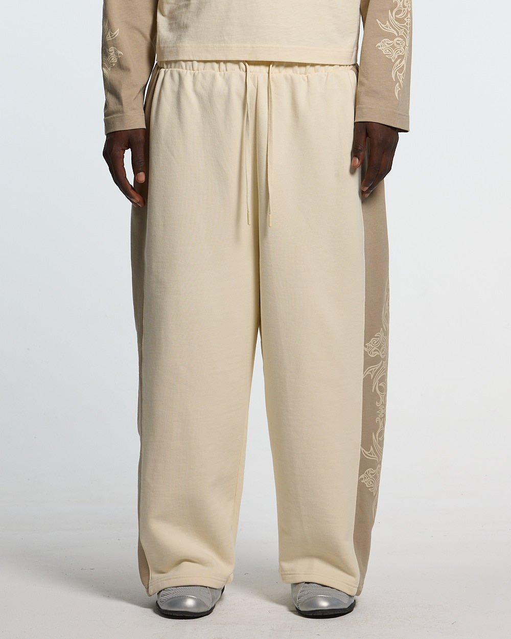 TRIBAL SWEATPANTS GREY & OFF WHITE - off white tribal sweatpants, front view on male model - Cold Culture