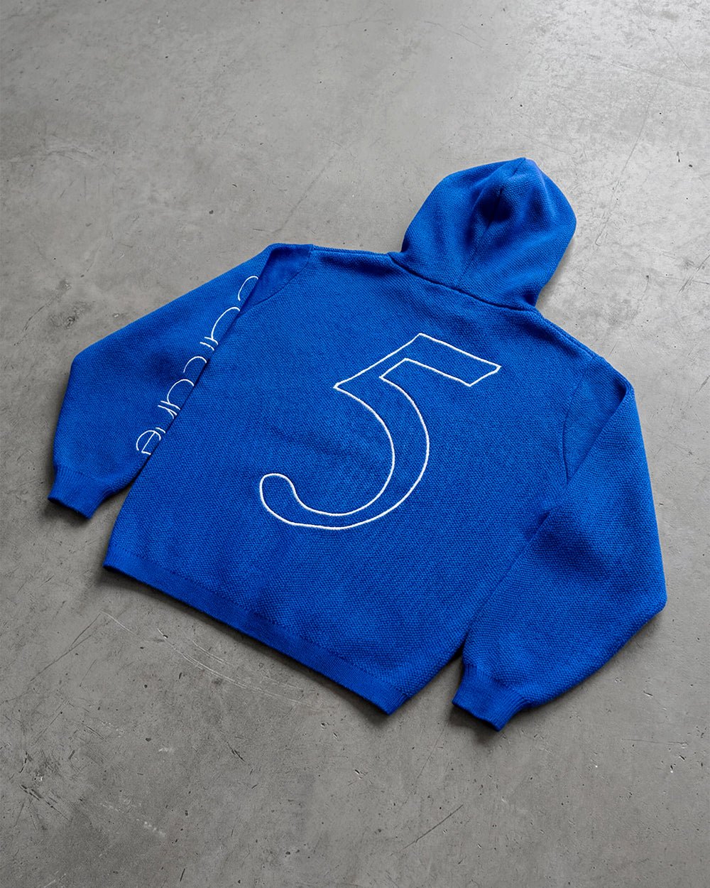 TRIPPY STOP ZIP KNIT BLUE - cobalt blue zip-up knit sweater, flat lay - Cold Culture