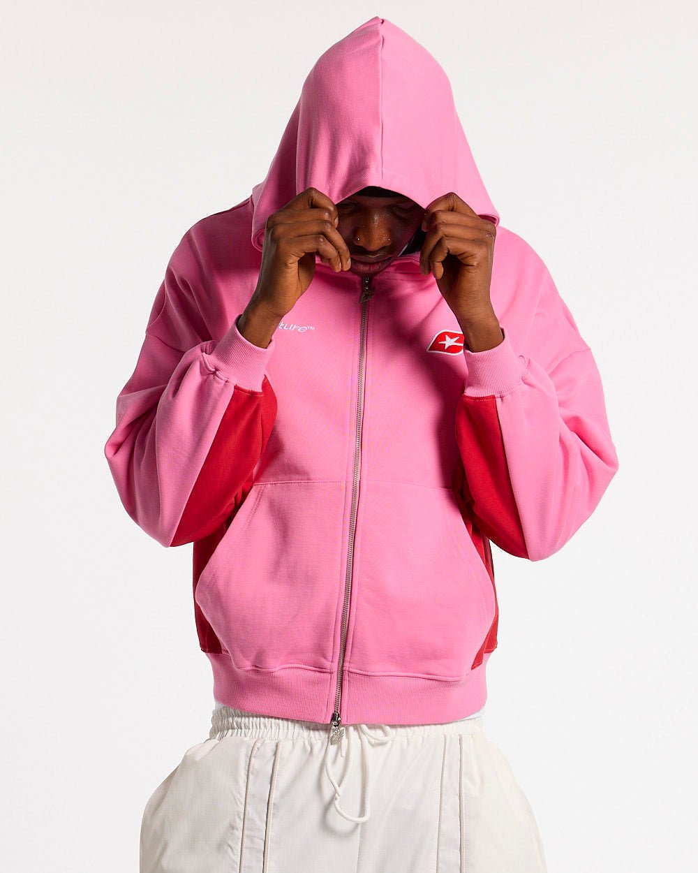TWISTTER ZIP HOODIE PINK - pink and red zip-up hoodie, front view on male model - Cold Culture