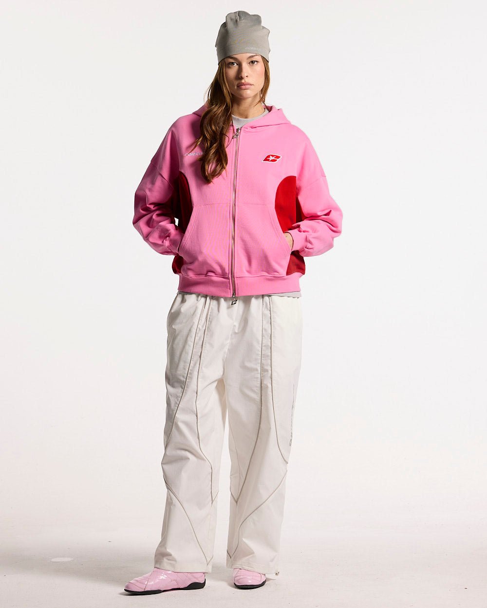 TWISTTER ZIP HOODIE PINK - pink and red zip-up hoodie, front view on female model - Cold Culture #woman