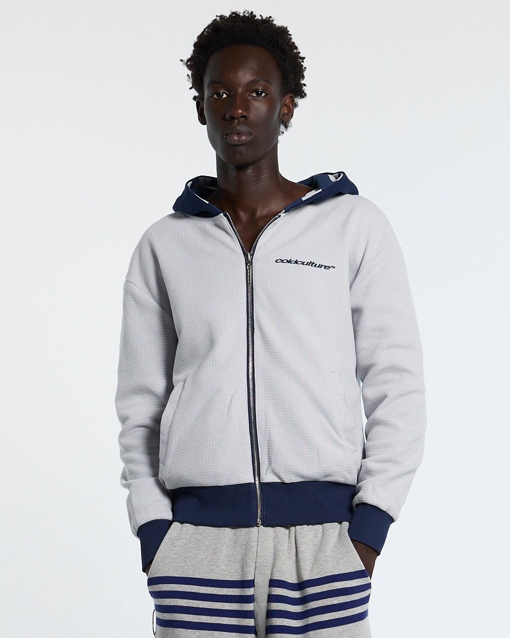 UNTRUE WAFFLE REVERSIBLE ZIP HOODIE BLUE - navy striped reversible zip-up hoodie, front view on male model - Cold Culture #man