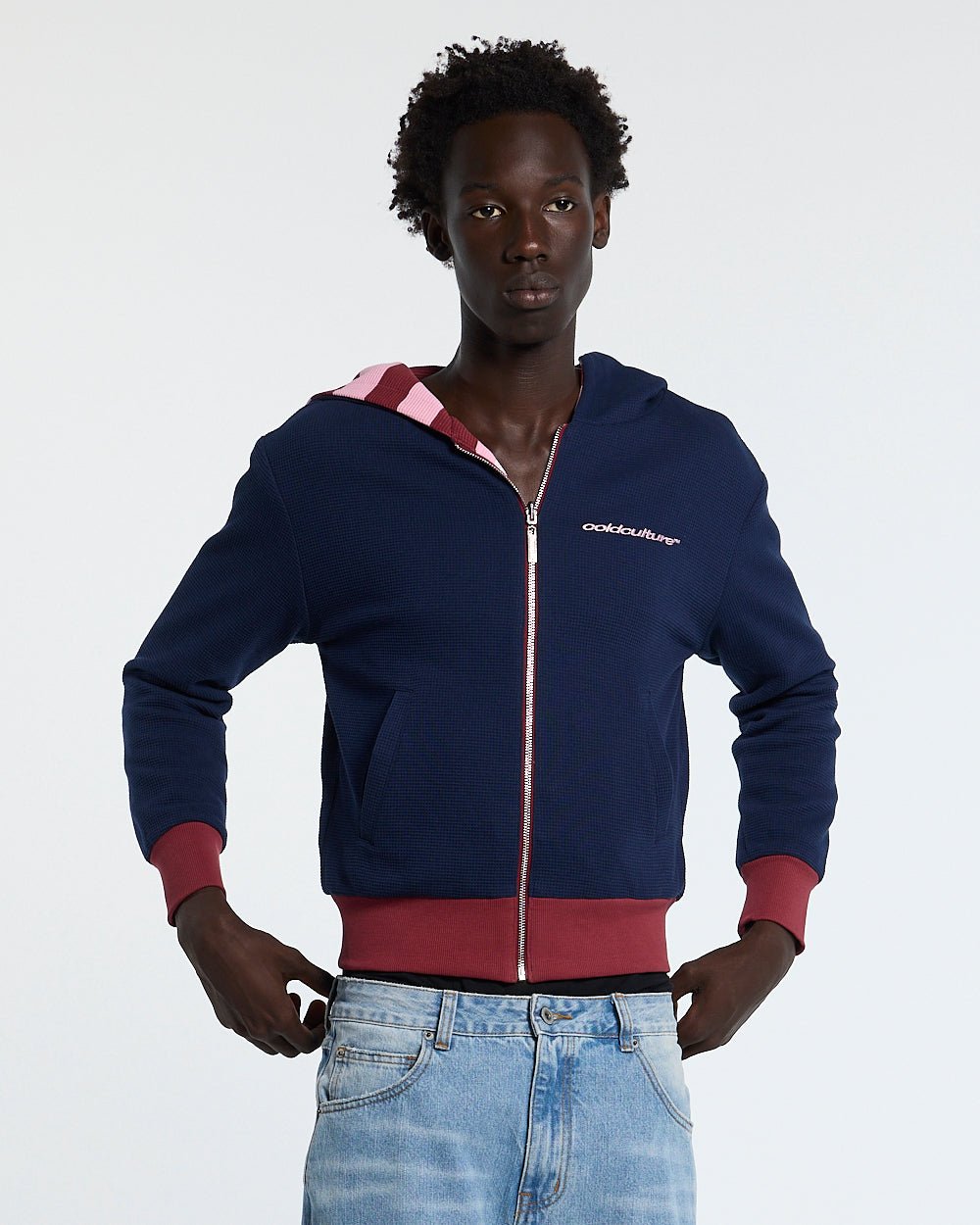 UNTRUE WAFFLE REVERSIBLE ZIP HOODIE PINK - pink striped reversible zip-up hoodie, front view on male model - Cold Culture #man