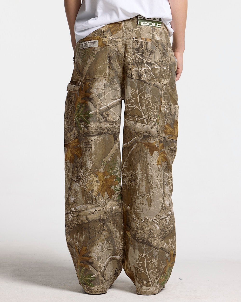 V1 CARPENTER PANTS REALTREE - realtree camo carpenter pants, back view on female model - Cold Culture