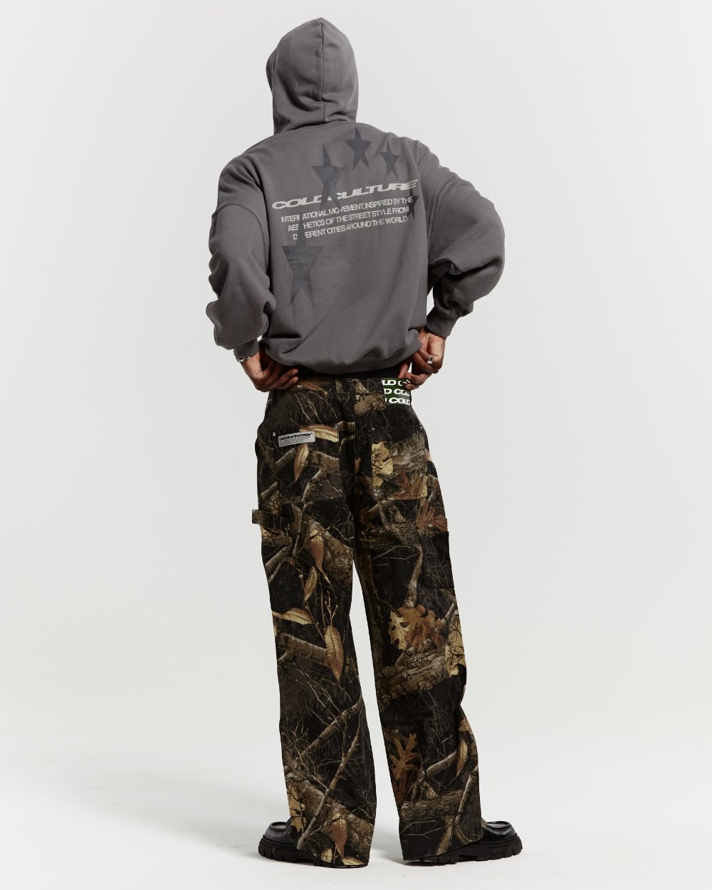 V1 CARPENTER PANTS REALTREE BLACK - black realtree camo carpenter pants, back view on male model - Cold Culture