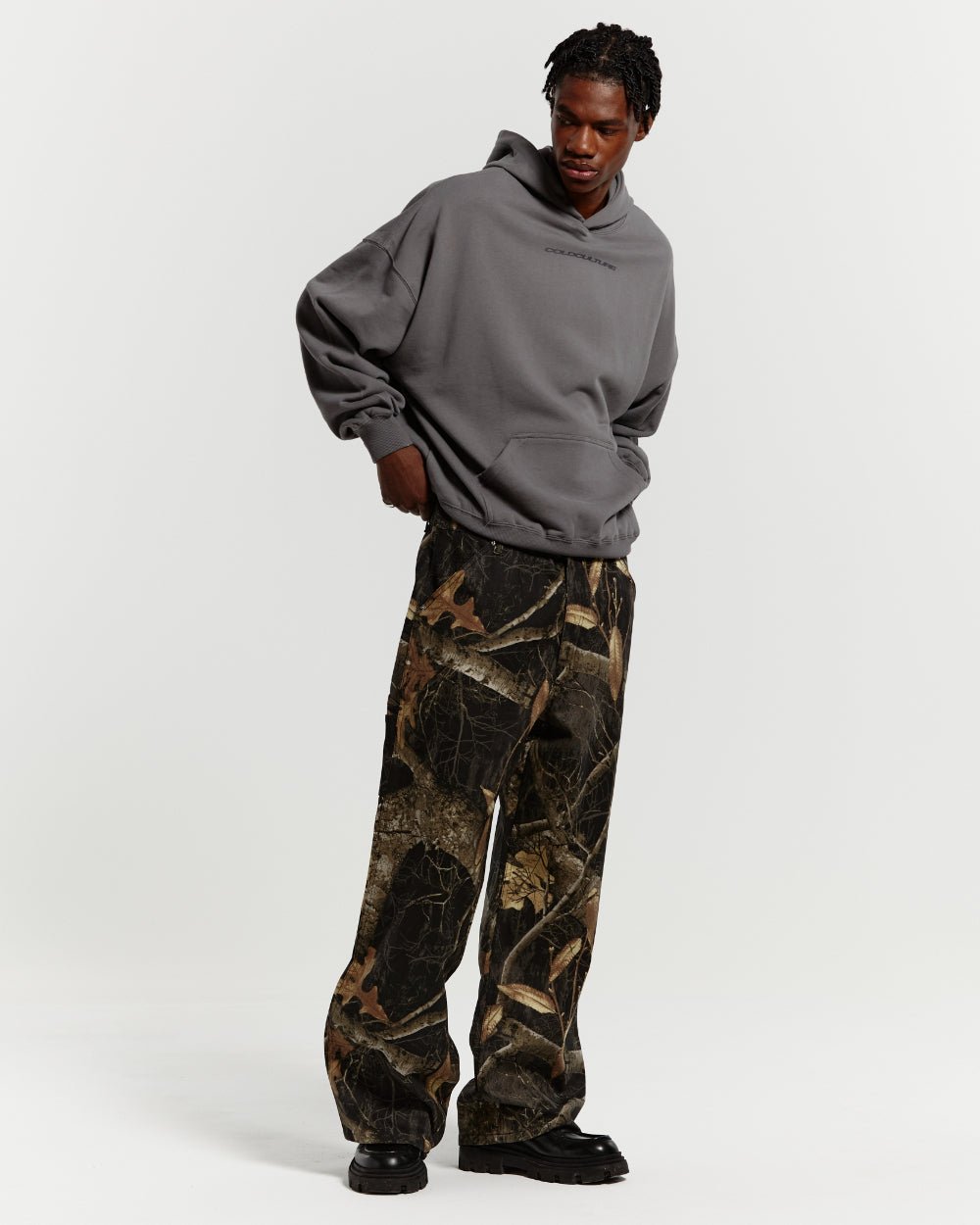 V1 CARPENTER PANTS REALTREE BLACK - black realtree camo carpenter pants, front view on male model - Cold Culture #man