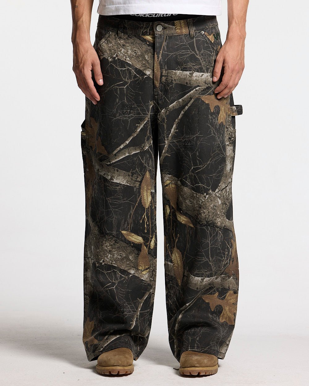 V1 CARPENTER PANTS REALTREE BLACK - black realtree camo carpenter pants, front view on male model - Cold Culture