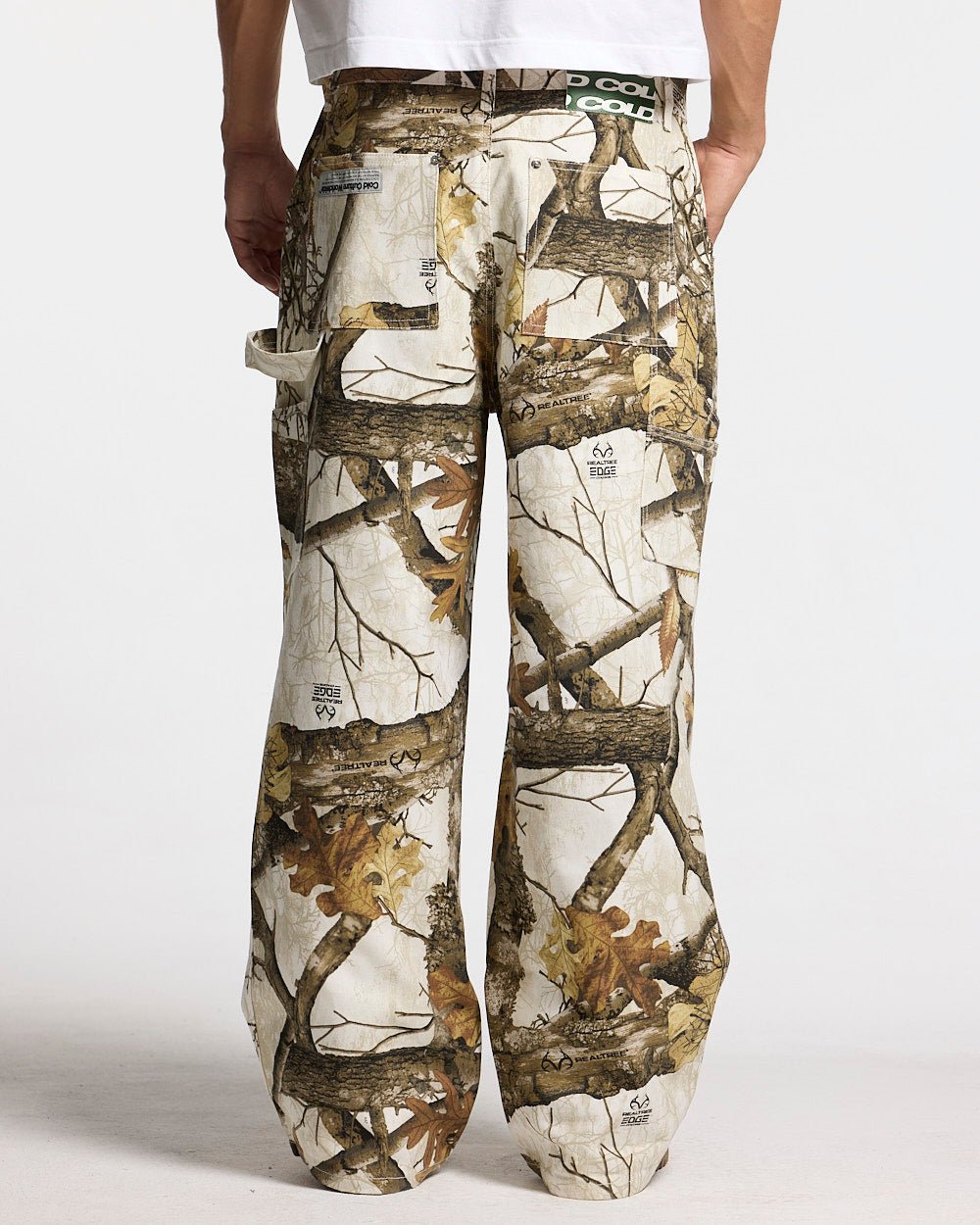 V1 CARPENTER PANTS REALTREE WHITE - white realtree camo carpenter pants, back view on male model - Cold Culture
