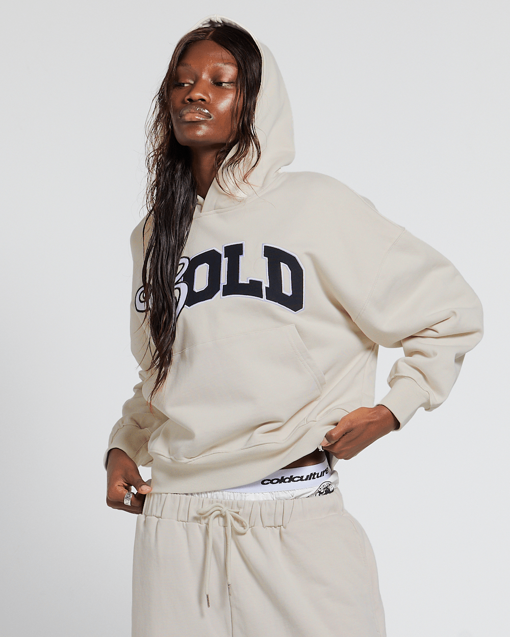 VARSITY HOODIE IVORY GREY - ivory varsity print hoodie, front view on female model - Cold Culture #woman