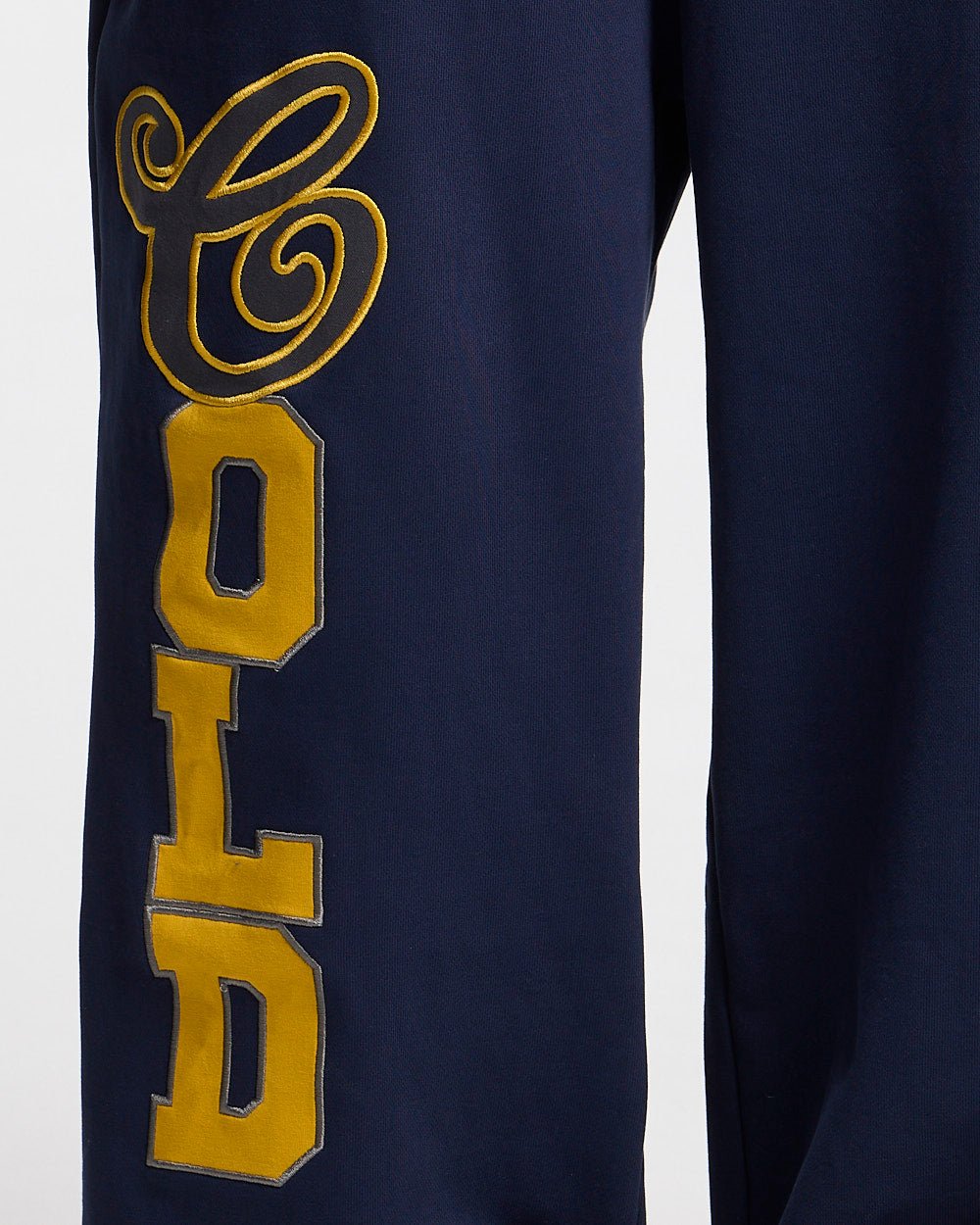 VARSITY PANTS DARK BLUE - navy blue baggy sweatpants, detail close-up - Cold Culture