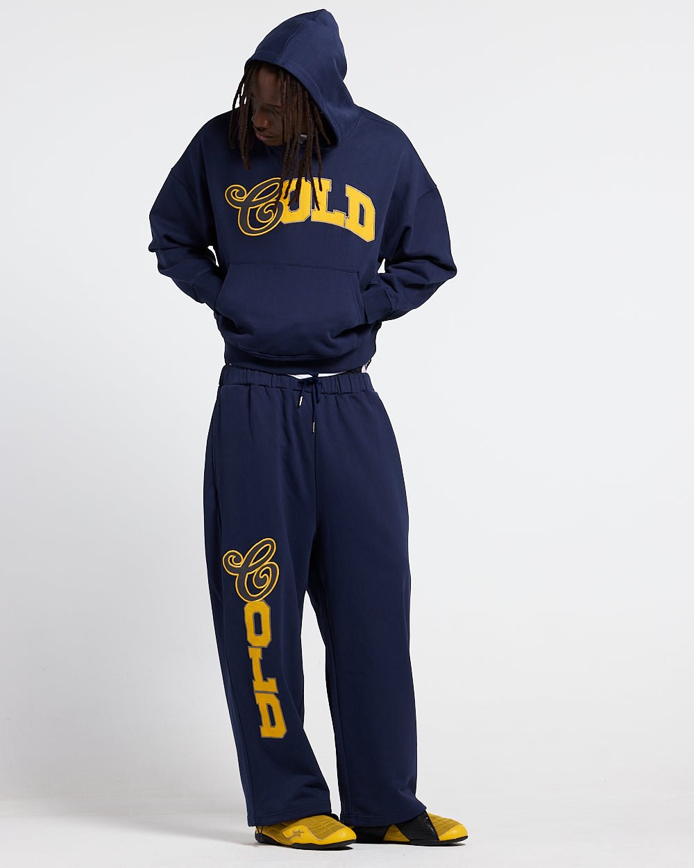 VARSITY PANTS DARK BLUE - navy blue baggy sweatpants, front view on male model - Cold Culture #man