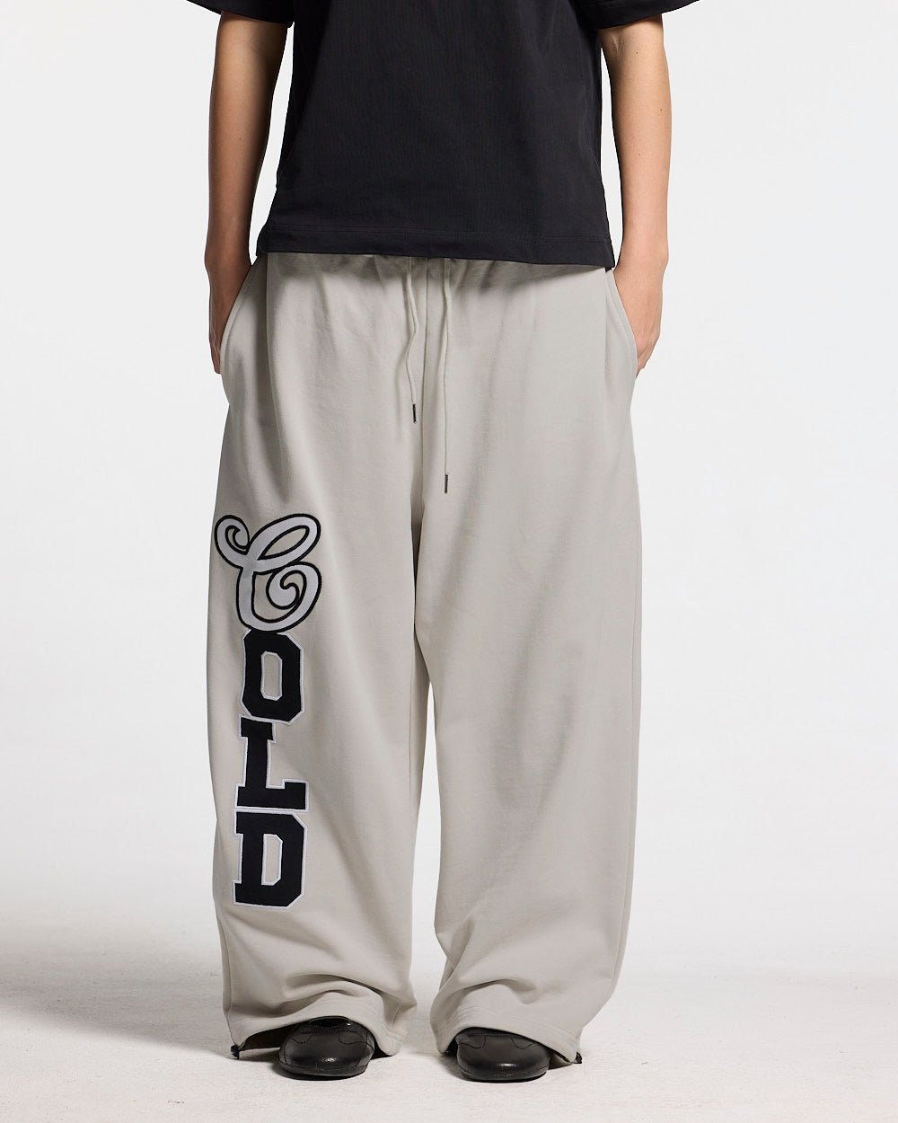 VARSITY PANTS IVORY GREY - ivory grey baggy sweatpants, front view on female model - Cold Culture #woman