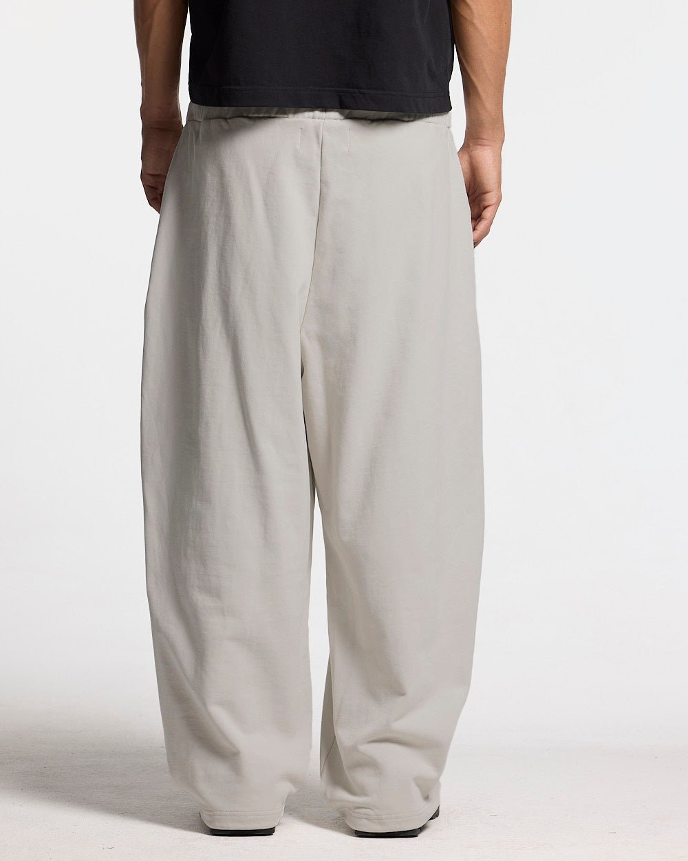 VARSITY PANTS IVORY GREY - ivory grey baggy sweatpants, back view on male model - Cold Culture