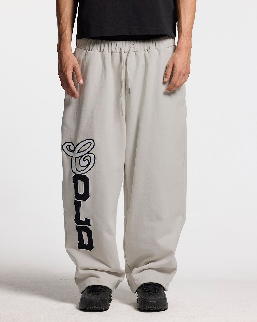 VARSITY PANTS IVORY GREY - ivory grey baggy sweatpants, front view on male model - Cold Culture
