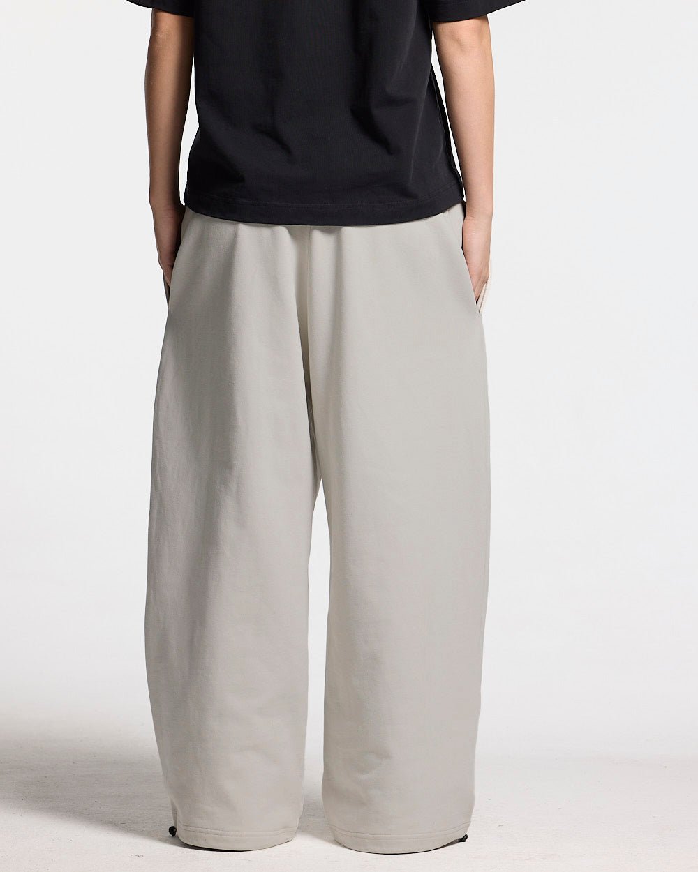 VARSITY PANTS IVORY GREY - ivory grey baggy sweatpants, back view on female model - Cold Culture #woman
