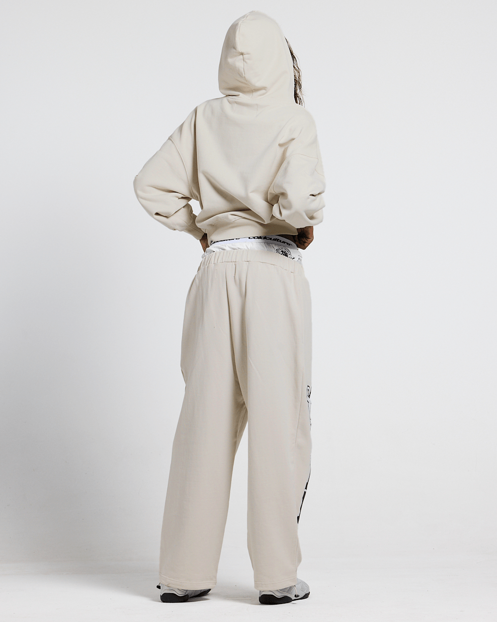 VARSITY PANTS IVORY GREY - ivory grey baggy sweatpants, back view on male model - Cold Culture