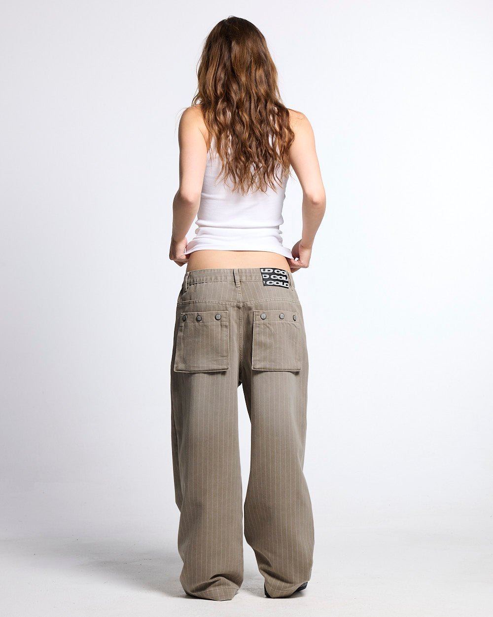 WASHED CASINO V1 PANTS BEIGE - beige pinstripe washed pants, back view on female model - Cold Culture #woman