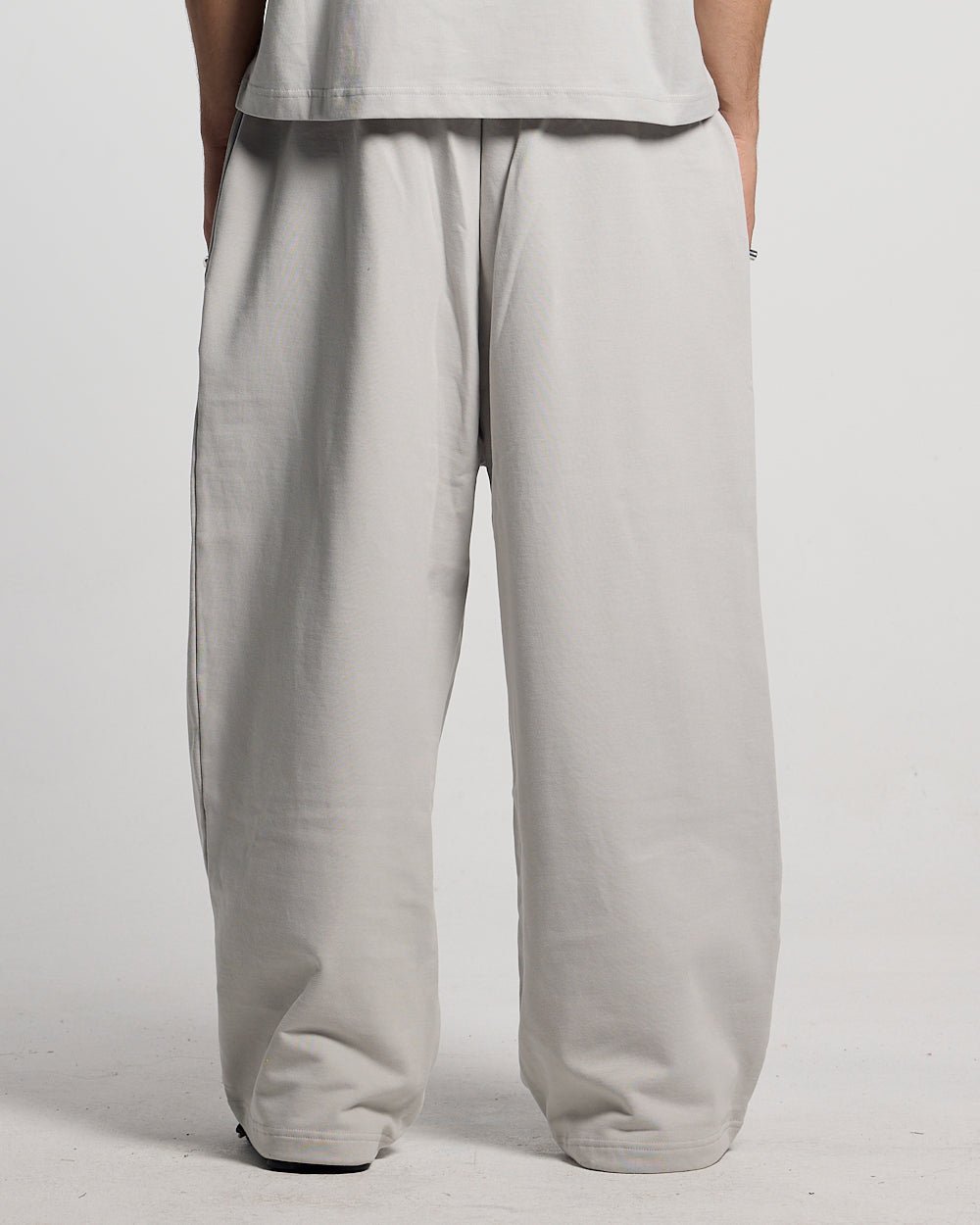 WILD CAMO SWEATPANTS LIGHT GREY - light grey baggy sweatpants, back view on male model - Cold Culture