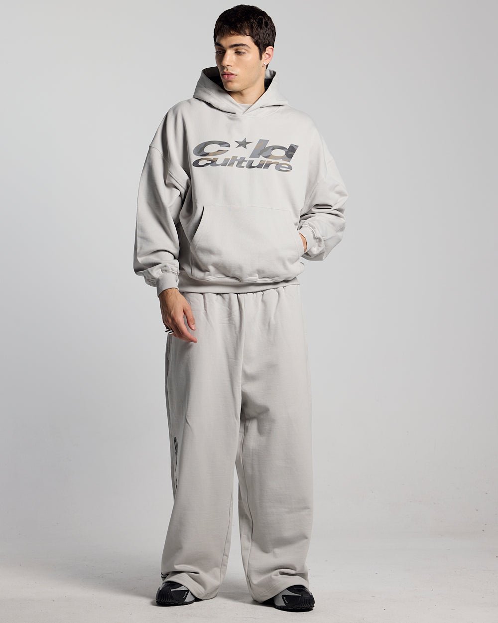 WILD CAMO SWEATPANTS LIGHT GREY - light grey baggy sweatpants, front view on male model - Cold Culture #man