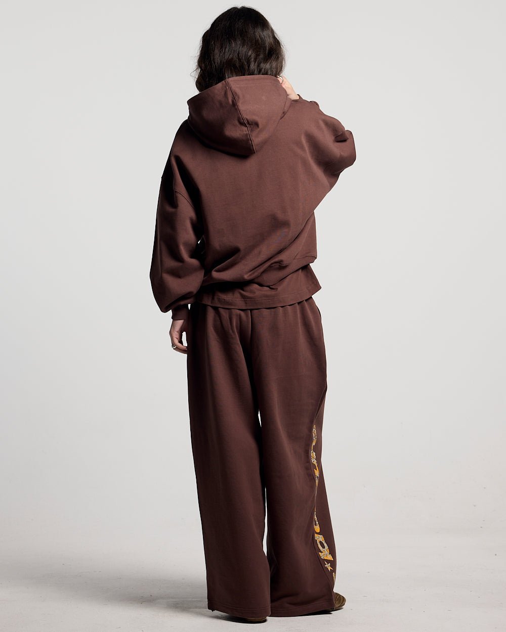 WILD SNAKE SWEATPANTS BROWN - brown baggy sweatpants, back view on female model - Cold Culture #woman