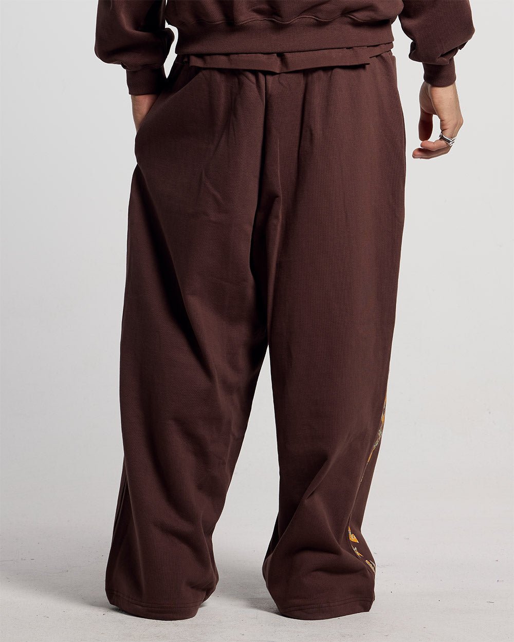 WILD SNAKE SWEATPANTS BROWN - brown baggy sweatpants, back view on male model - Cold Culture