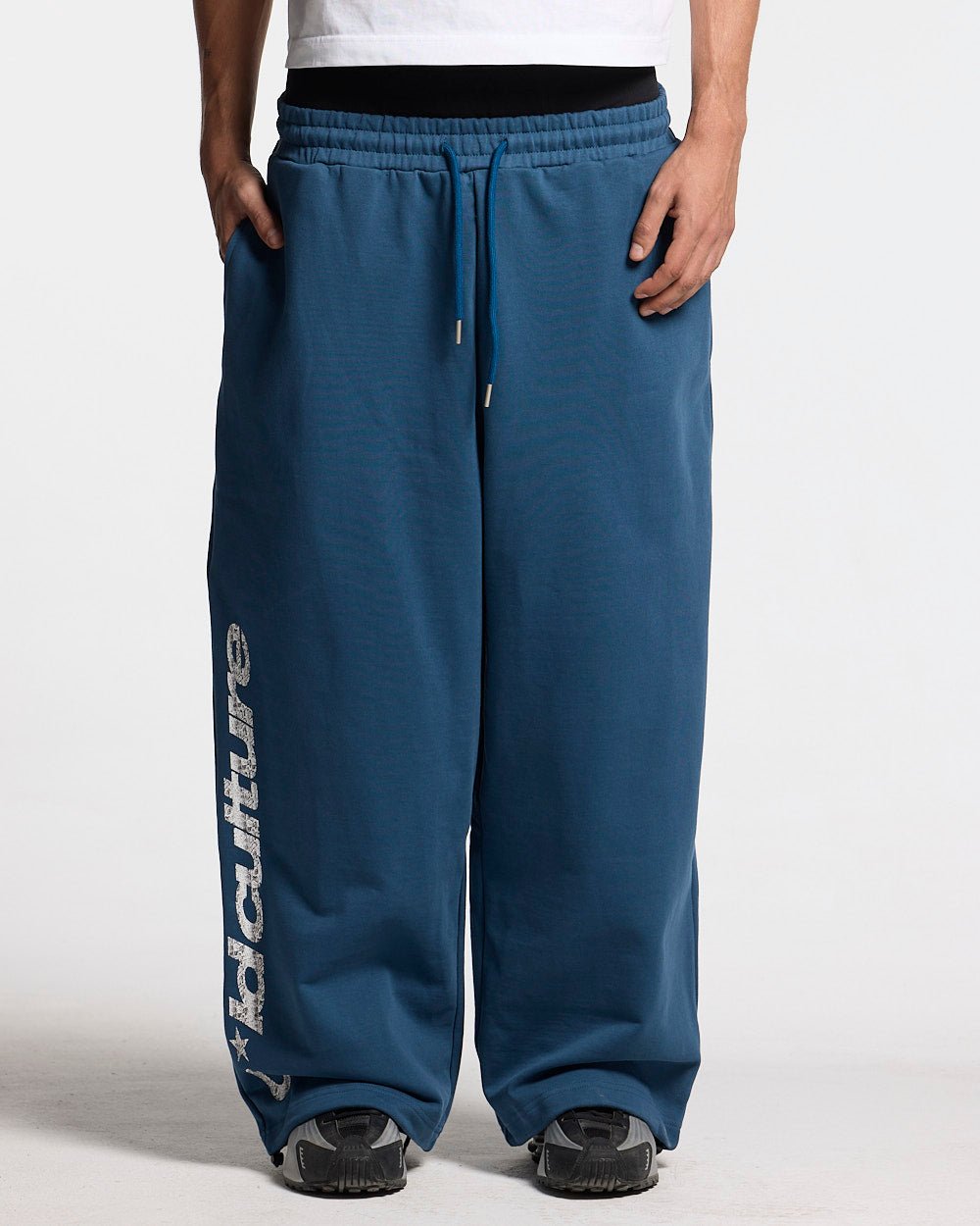 WILD SNAKE SWEATPANTS NAVY BLUE - navy blue baggy sweatpants, front view on male model - Cold Culture