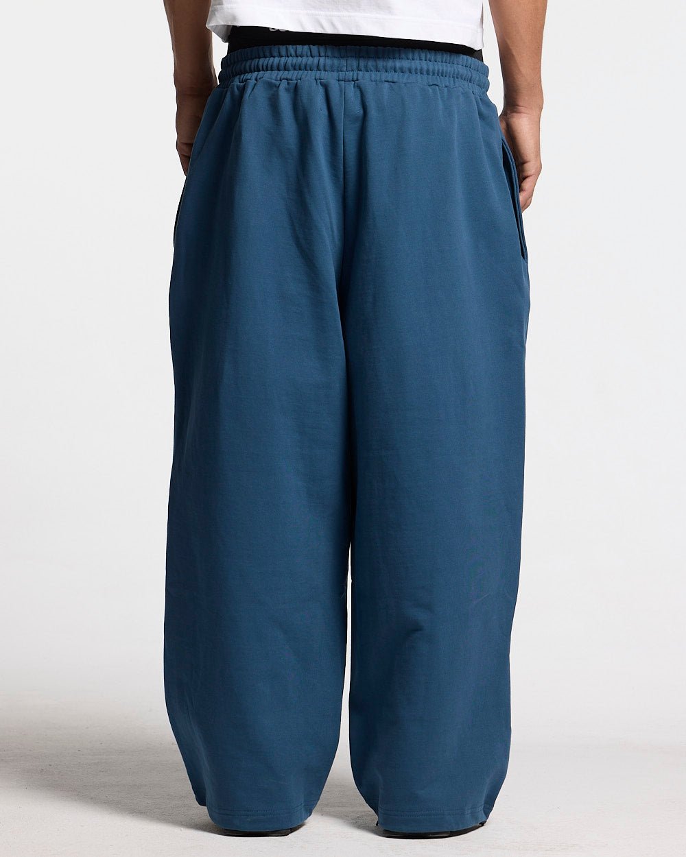 WILD SNAKE SWEATPANTS NAVY BLUE - navy blue baggy sweatpants, back view on male model - Cold Culture