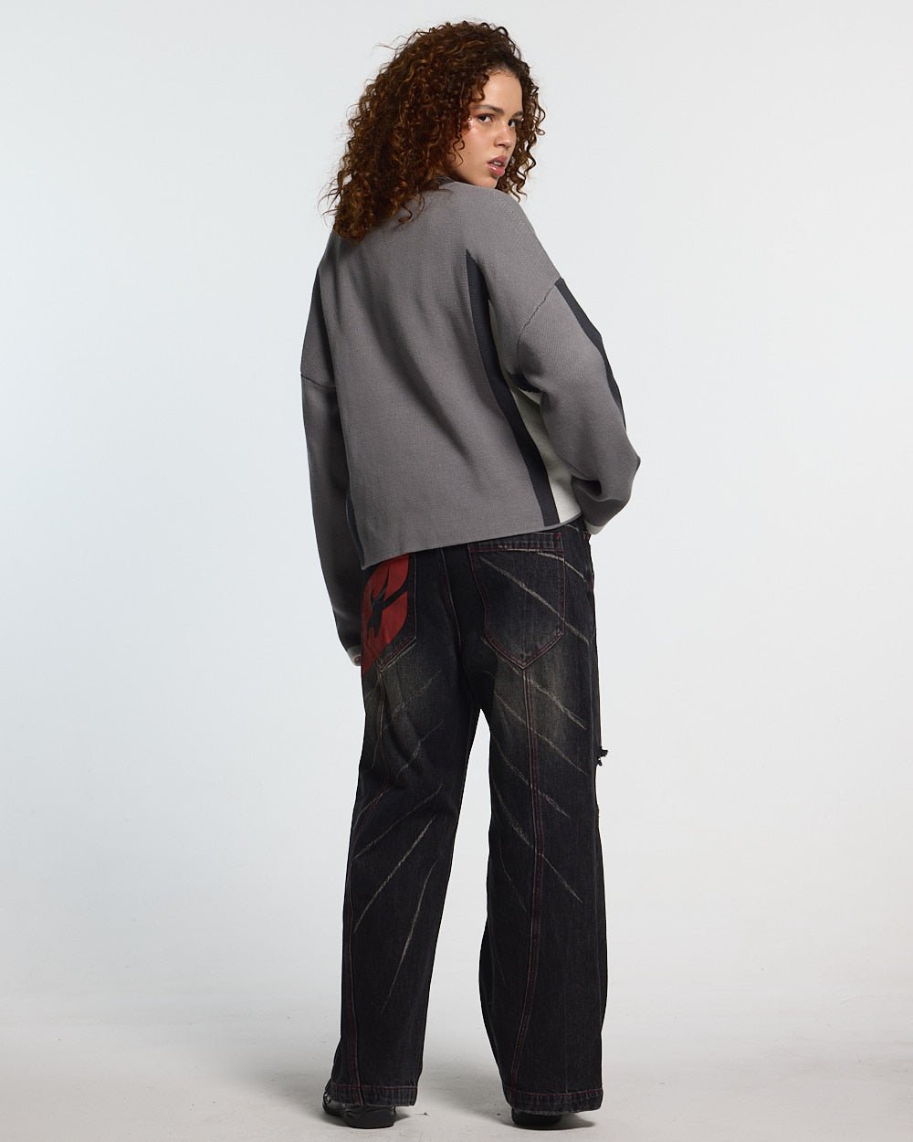 WINNER KNIT GREY, BLACK AND WHITE - grey and black knit sweater, back view on female model - Cold Culture #woman