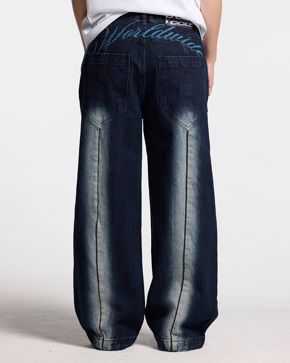 WORLDWIDE V2 PANTS DARK DENIM - dark denim baggy pants, back view on female model - Cold Culture #woman