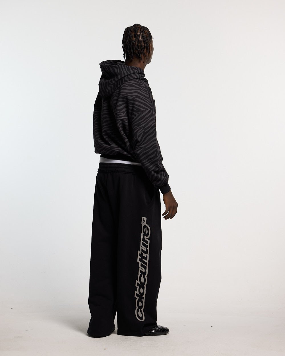 ZEBRA HOODIE BLACK - black zebra print hoodie, side view - Cold Culture