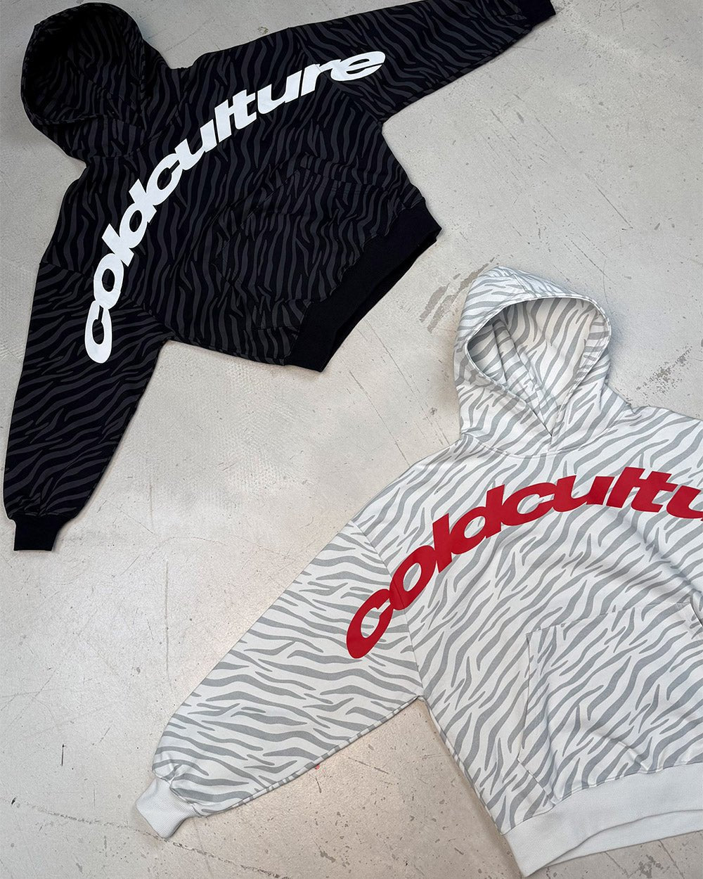 ZEBRA HOODIE BLACK - black zebra print hoodie, flat lay with matching pieces - Cold Culture