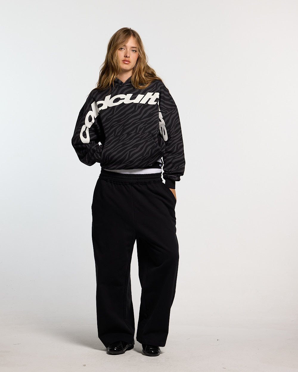 ZEBRA HOODIE BLACK - black zebra print hoodie, front view on female model - Cold Culture #woman